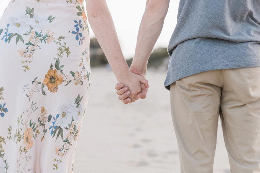 A photo of a man and woman holding hands