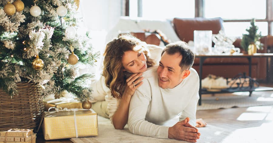 Ukrainian man and woman decorating Christmas tree