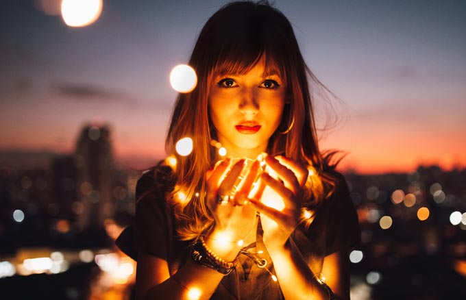 Woman holding fairy lights.