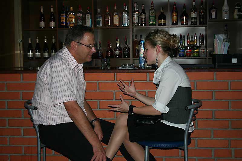 A photo of a man having a conversation with a Ukraine girl